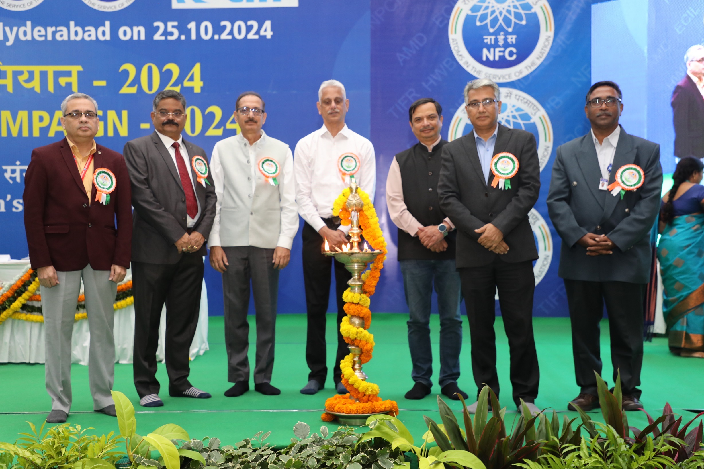 Lighting of the lamp by the dignitaries on the dais.