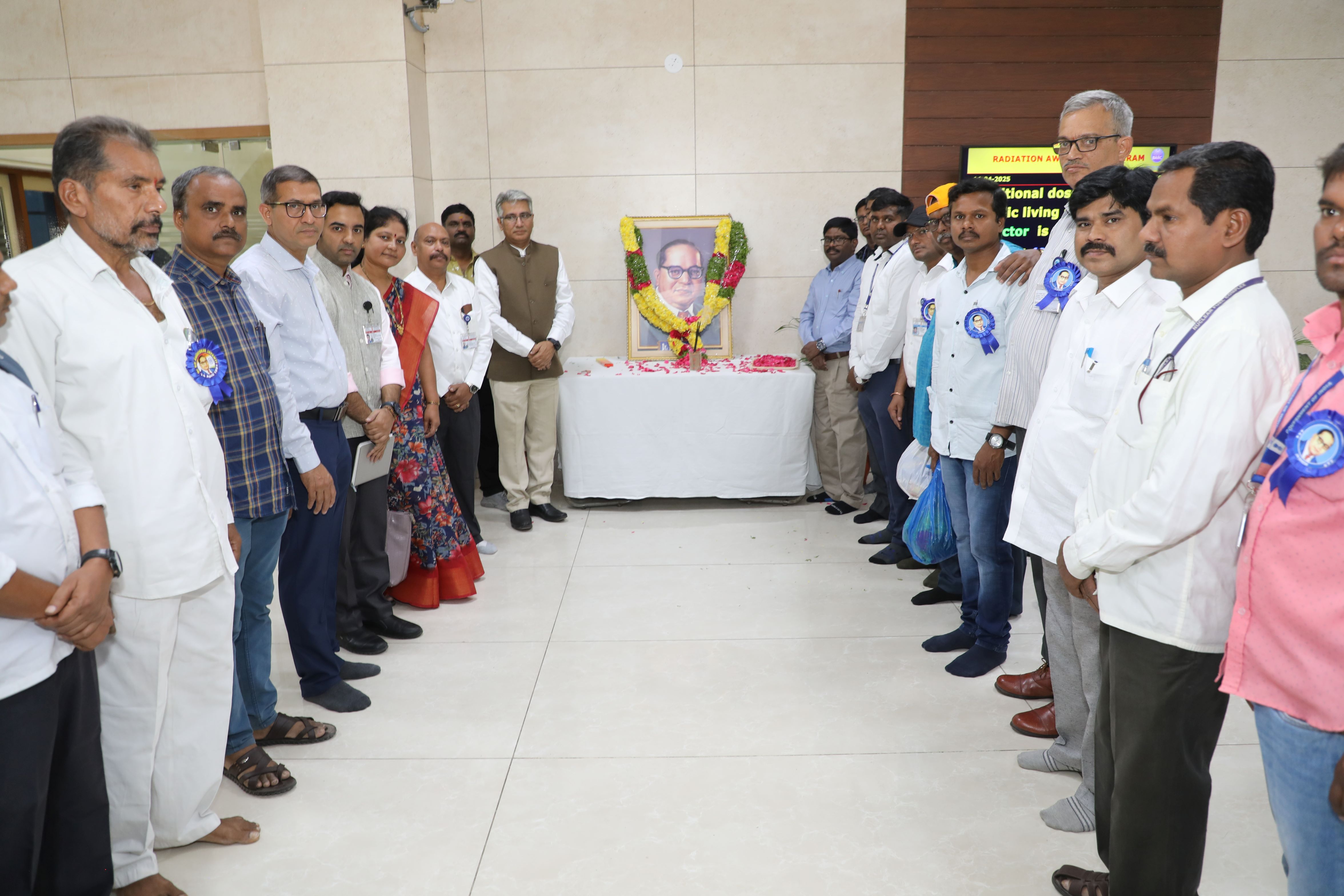 Chief Guest, Guest of Honour and employees of NFC paying Tributes to Dr. B.R. Ambedkar portrait.