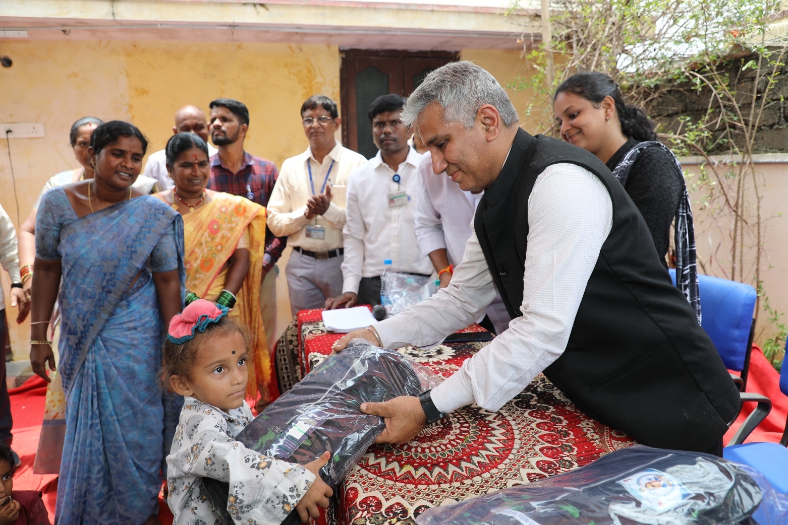 Chief Guest Dr. Komal Kapoor, Chairman & Chief Executive, NFC distributing school books and bags to the students.