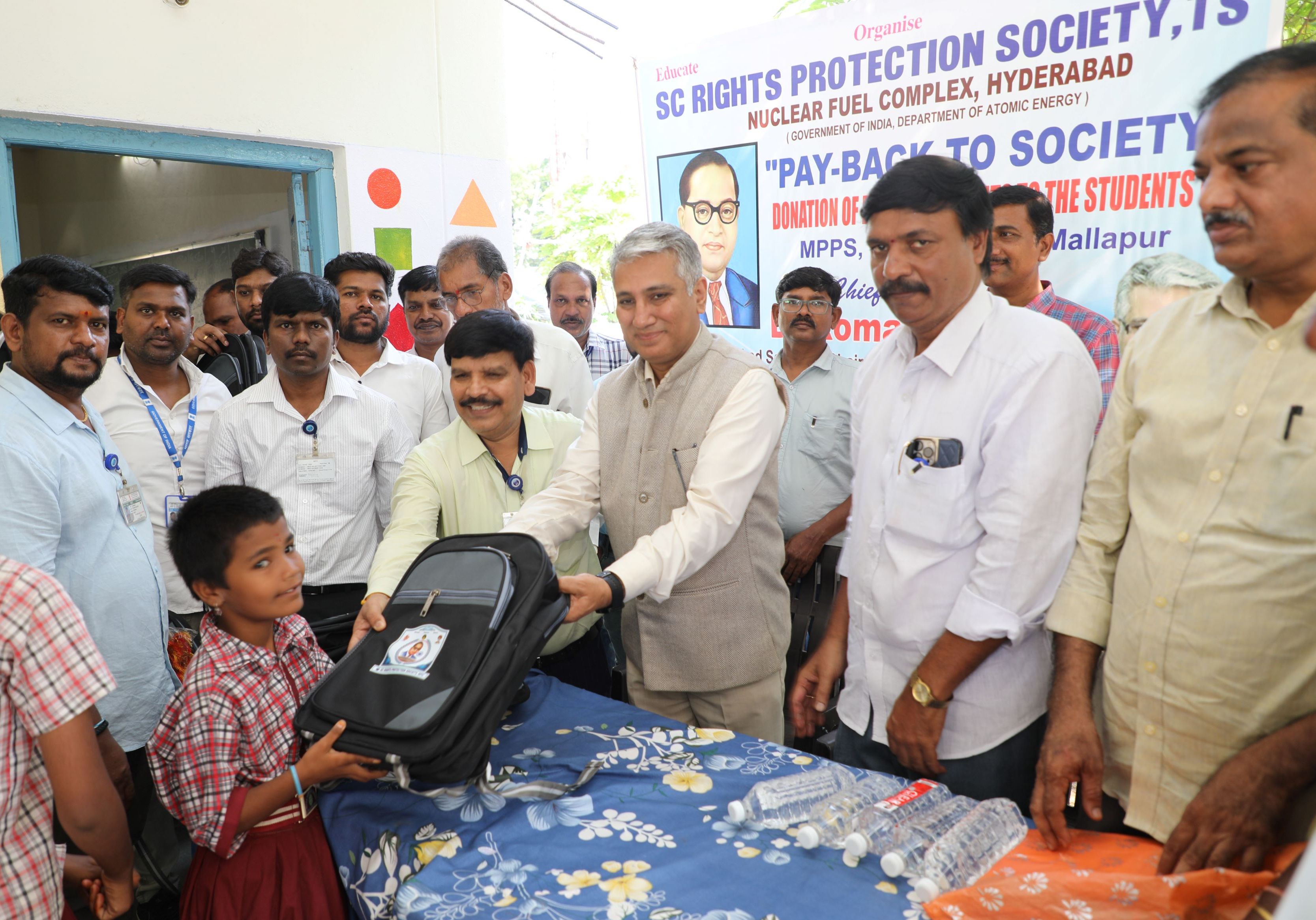 Chief Guest Dr. Komal Kapoor, Chairman & Chief Executive, NFC distributing school books and bags to the students.