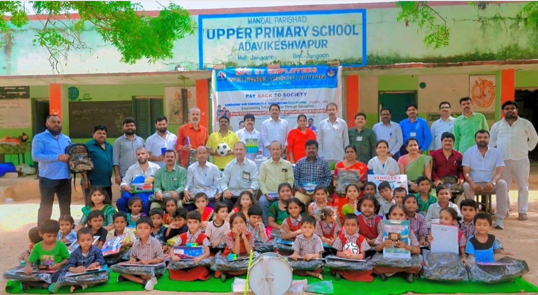 Distribution to students school kit with group photo.
