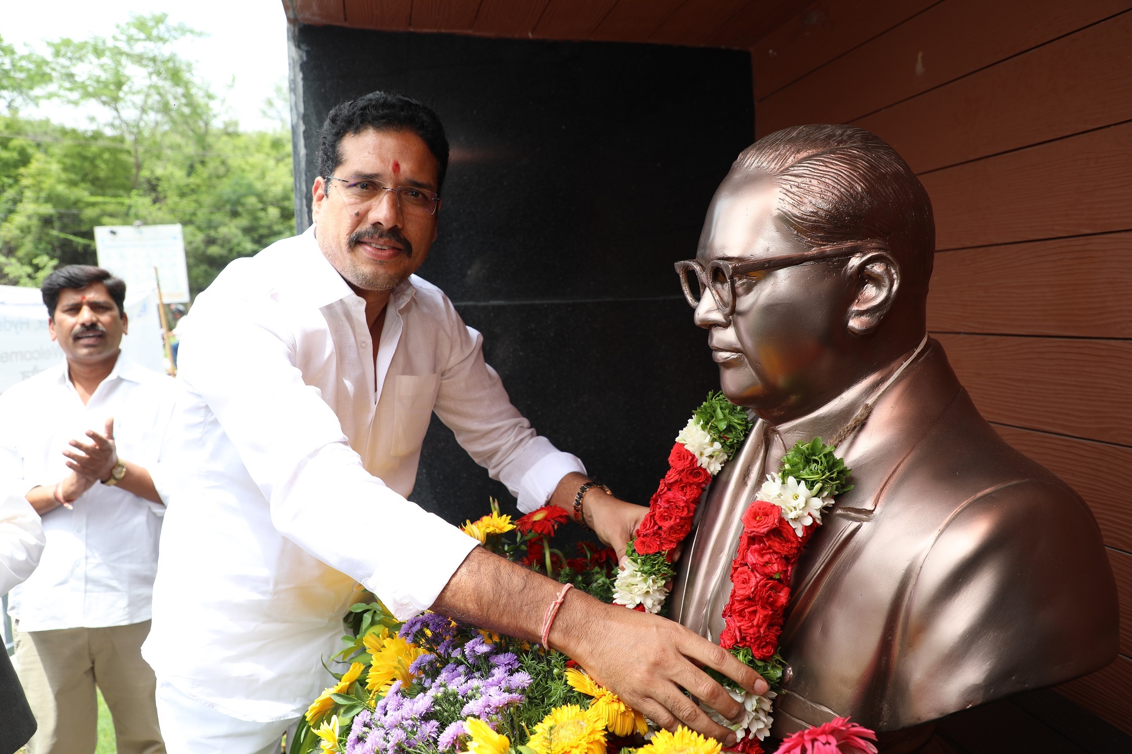  Shri Jatothu Hussain, Hon'ble Member, National Commission for ST garlanding the burst of Dr. B.R. Ambedkar.